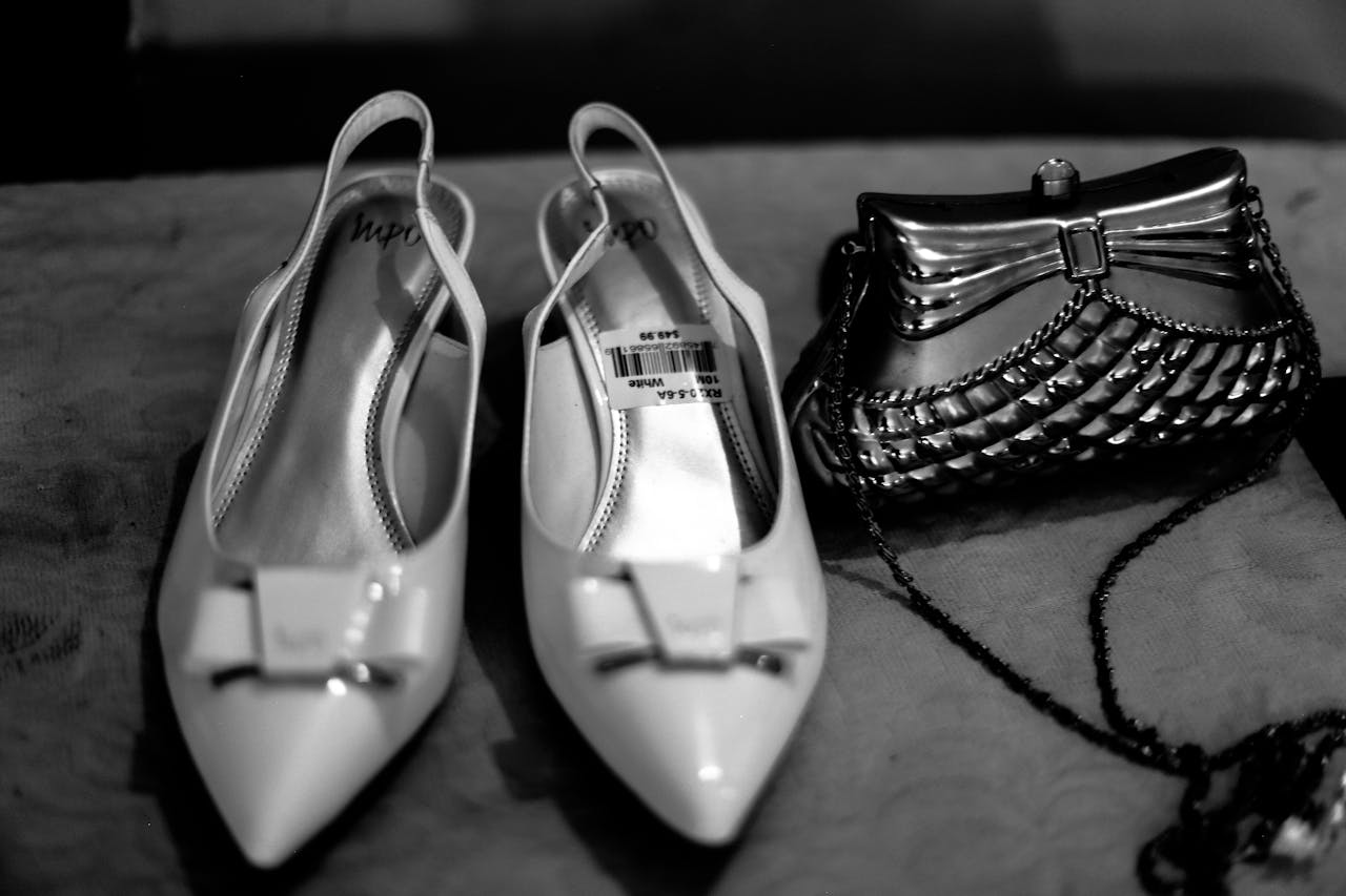 Elegant black and white photo featuring high heels and a clutch bag, ideal for fashion themes.